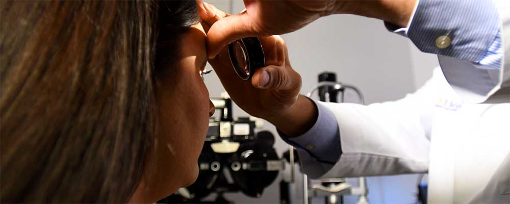 University of Florida ophthalmologist examines patient